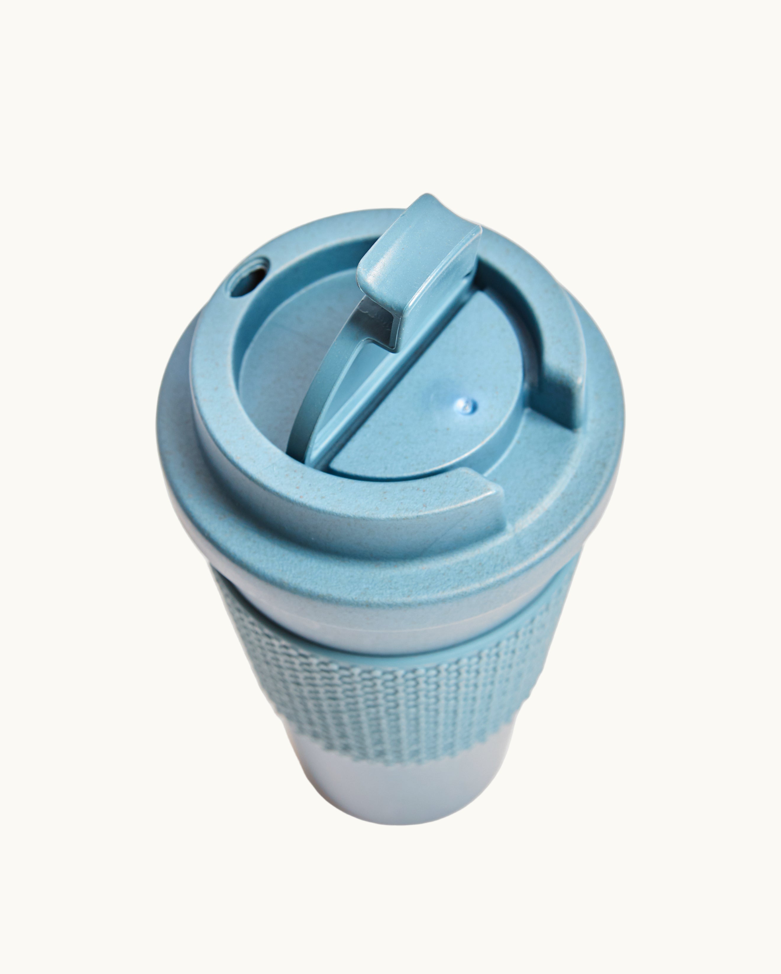 Blue compostable 16oz tumbler with lid, co-brand for sustainable swag and premium eco swag