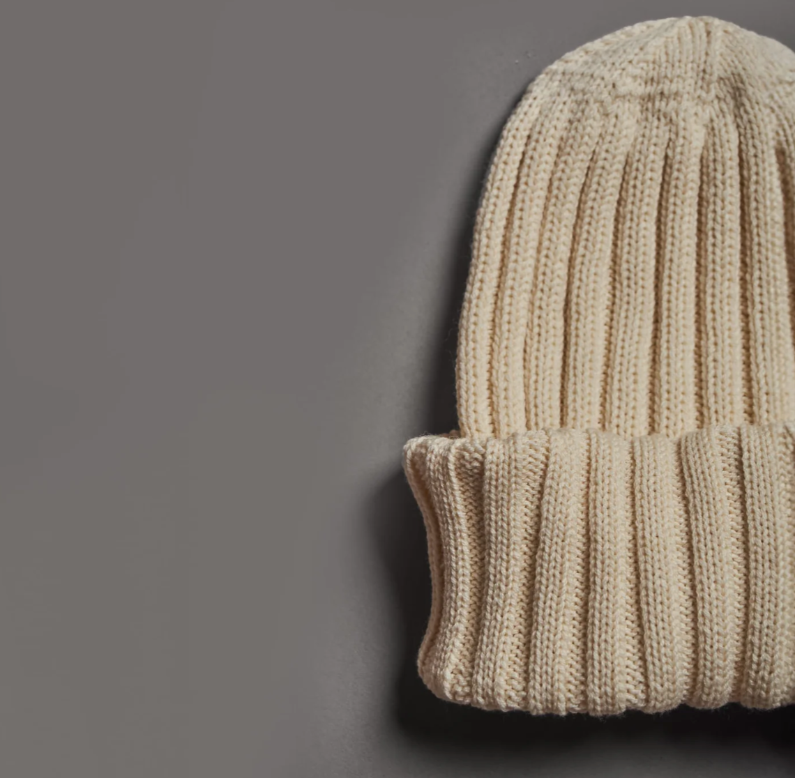 Close-up of beige merino wool beanie hand knitted in Patagonia for premium corporate gifts