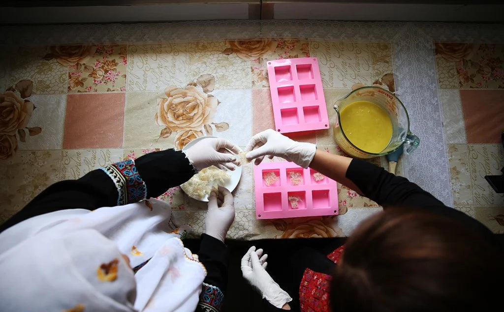 Palestinian women making olive oil soap as part of Sitti, a women-owned brand preserving traditional craftsmanship