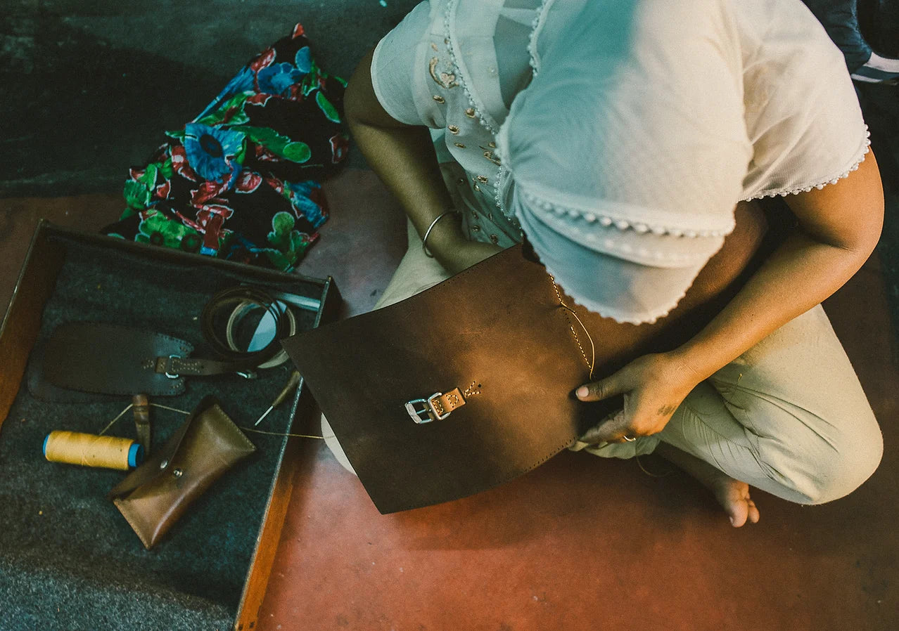Artisan from The Loyal Workshop hand stitching eco-tanned leather products