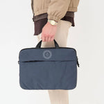 Blue recycled laptop briefcase personalised with company logo being carried by hand