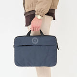 Blue recycled laptop briefcase personalised with company logo being carried by hand