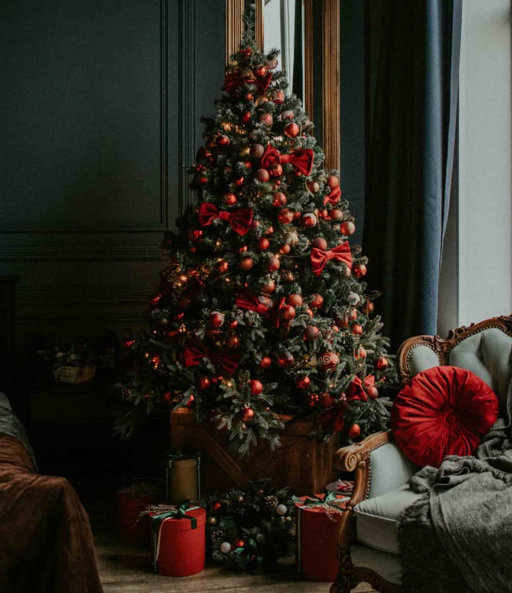 Corporate Christmas gifts under a tree decorated for the festive season