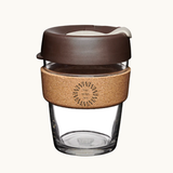 12oz reusable glass cup with natural cork band and brown lid. Sustainable corporate gifts
