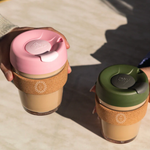 12oz reusable glass cup with natural cork band, sustainable corporate gift for employees and clients.