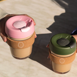 12oz reusable glass cup with natural cork band, sustainable corporate gift for employees and clients.