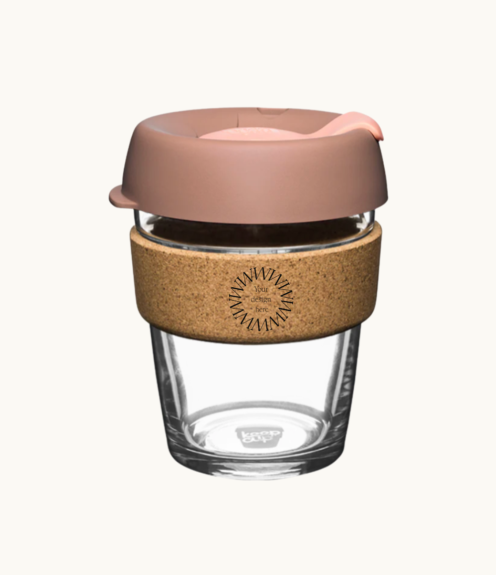 12oz reusable glass cup with natural cork band and rose pink lid. Sustainable corporate gifts