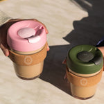 12oz reusable glass cup with natural cork band, sustainable corporate gift for employees and clients.