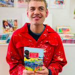 ARTHOUSE Unlimited artist holding a Sea of Daffodils dark chocolate buttons bag