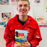 ARTHOUSE Unlimited artist holding a Sea of Daffodils dark chocolate buttons bag