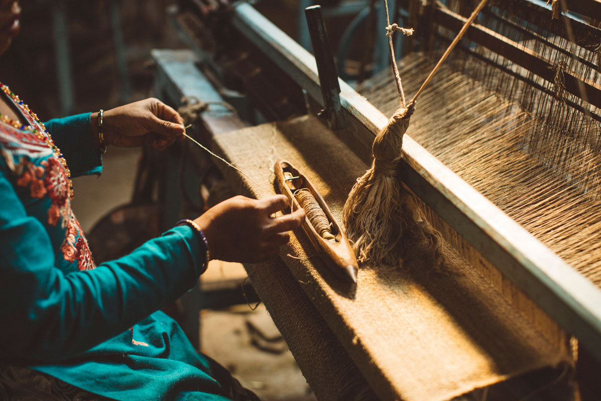 An artisan woman weaving in a traditional loom, keeping the local traditions alive