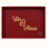 Red desk tray personalised with gold Bits and Pieces lettering showing logo placement