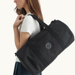 Lifestyle photo of black recycled PET multipurpose water resistant duffle bag eco friendly best corporate swag