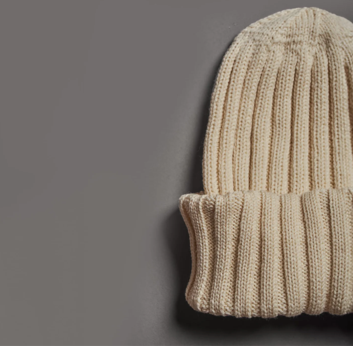 Close-up of beige merino wool beanie hand knitted in Patagonia for premium corporate gifts