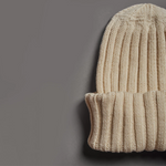 Close-up of beige merino wool beanie hand knitted in Patagonia for premium corporate gifts