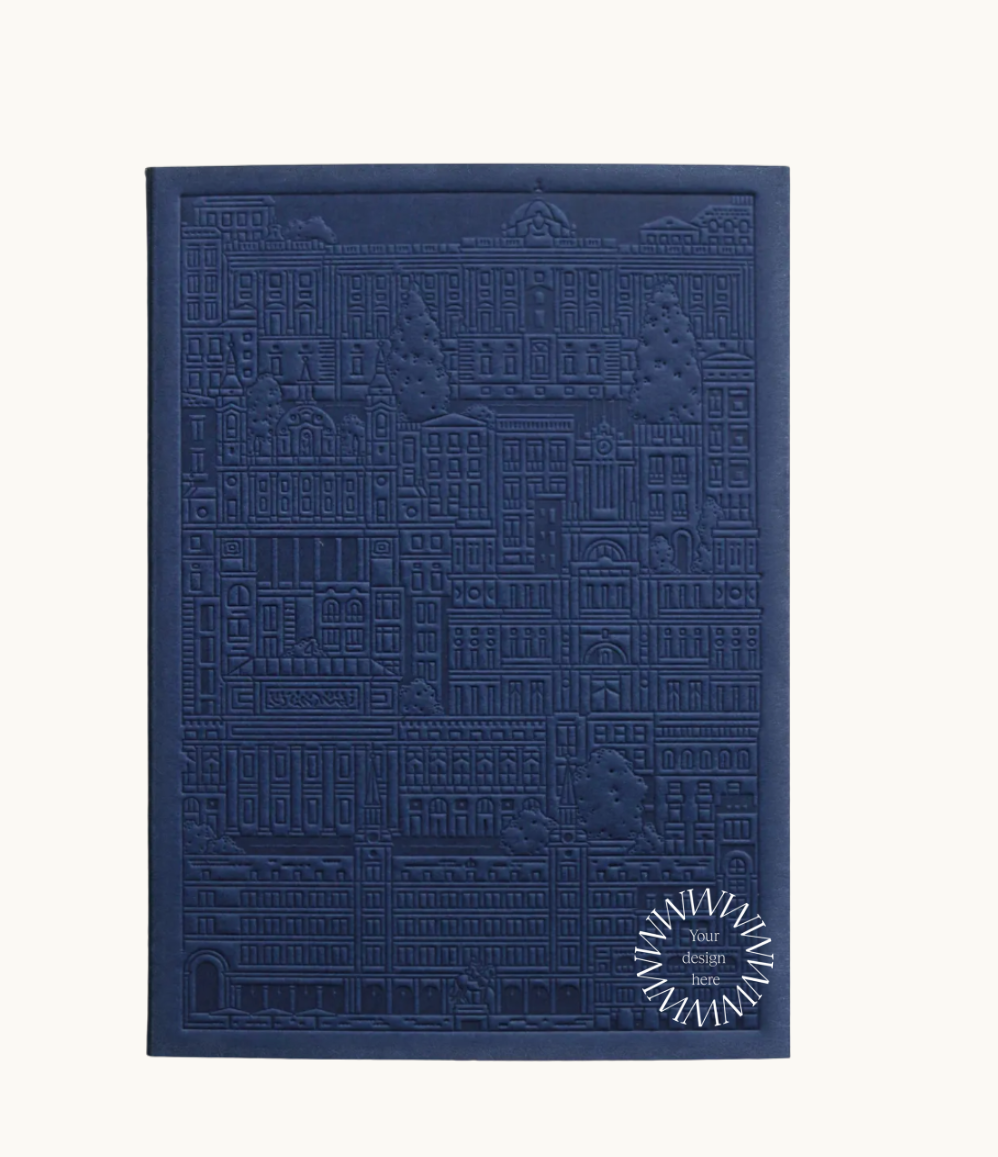 Blue notebook with embossed design of the city of Madrid. Personalised corporate gift from women-owned brands