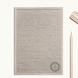 Grey notebook with embossed design of the city of Madrid. Personalised corporate gift from women-owned brands