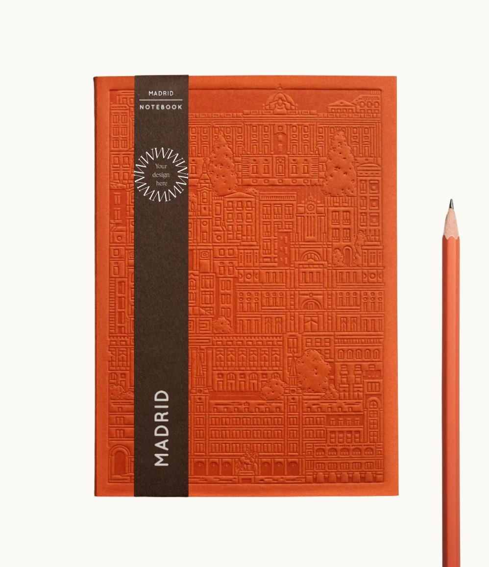 orange notebook with embossed design of the city of Madrid. Personalised corporate gift from women-owned brands