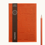 orange notebook with embossed design of the city of Madrid. Personalised corporate gift from women-owned brands
