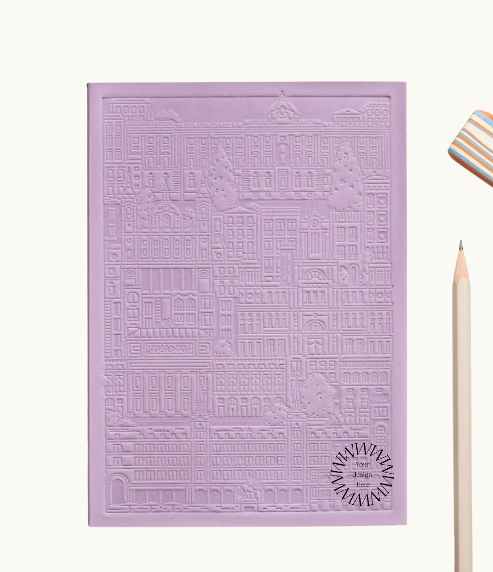 Purple notebook with embossed design of the city of Madrid. Personalised corporate gift from women-owned brands