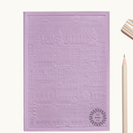 Purple notebook with embossed design of the city of Madrid. Personalised corporate gift from women-owned brands