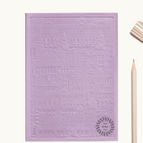 Purple notebook with embossed design of the city of Madrid. Personalised corporate gift from women-owned brands