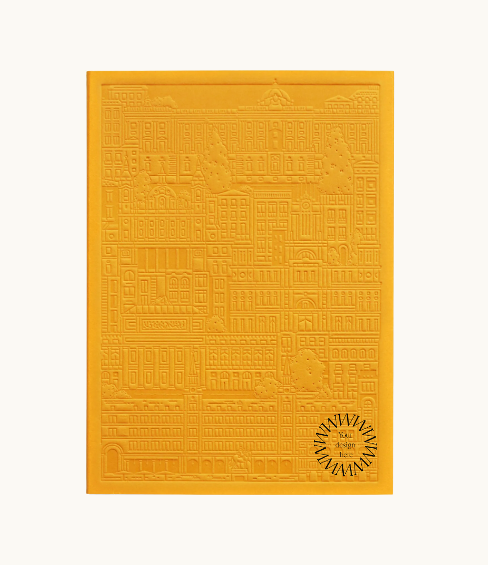 Yellow notebook with embossed design of the city of Madrid. Personalised corporate gift from women-owned brands