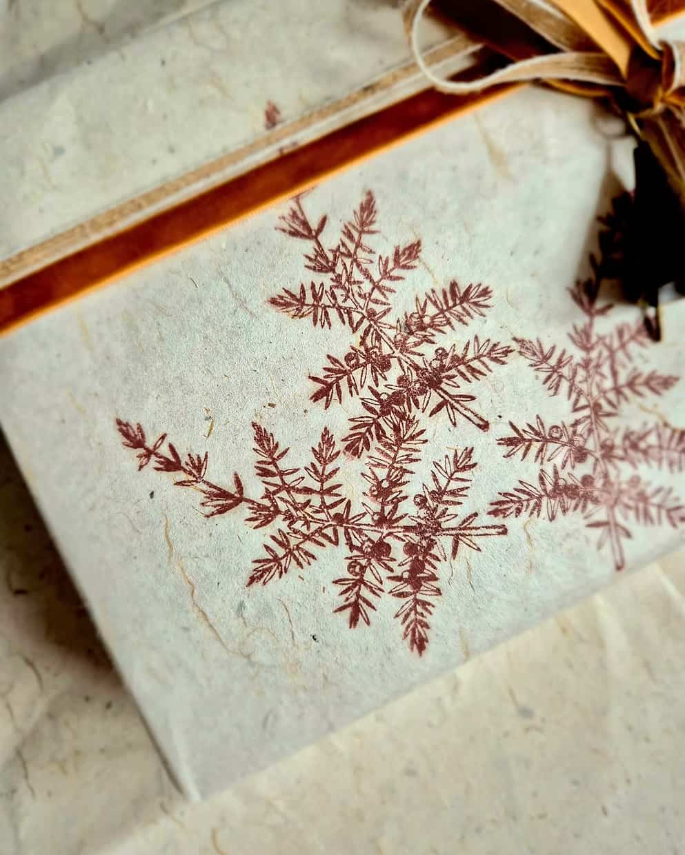 Hand stamped gift wrapping paper with botanical design and velvet ribbon