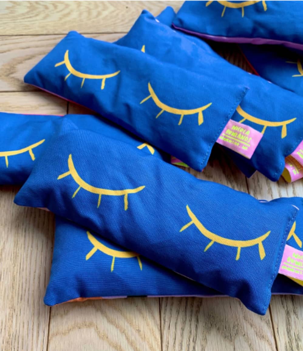 Blue handmade lavender eye bags with yellow closed eyes design