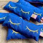 Blue handmade lavender eye bags with yellow closed eyes design
