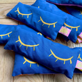 Blue handmade lavender eye bags with yellow closed eyes design