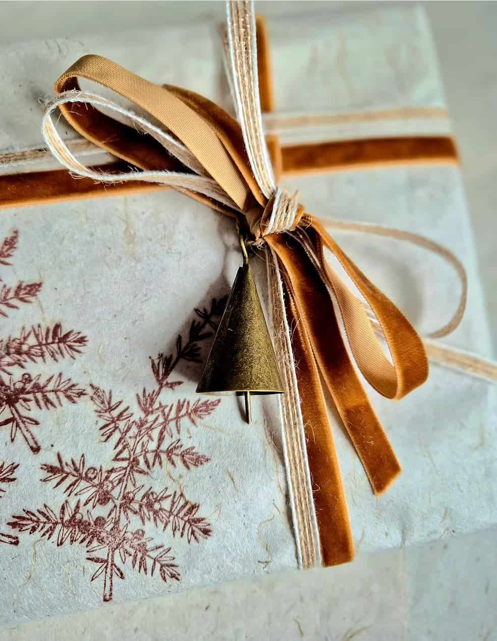 Gift set wrapping with velvet ribbon and bronze coloured bell