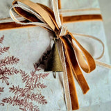 Gift set wrapping with velvet ribbon and bronze coloured bell