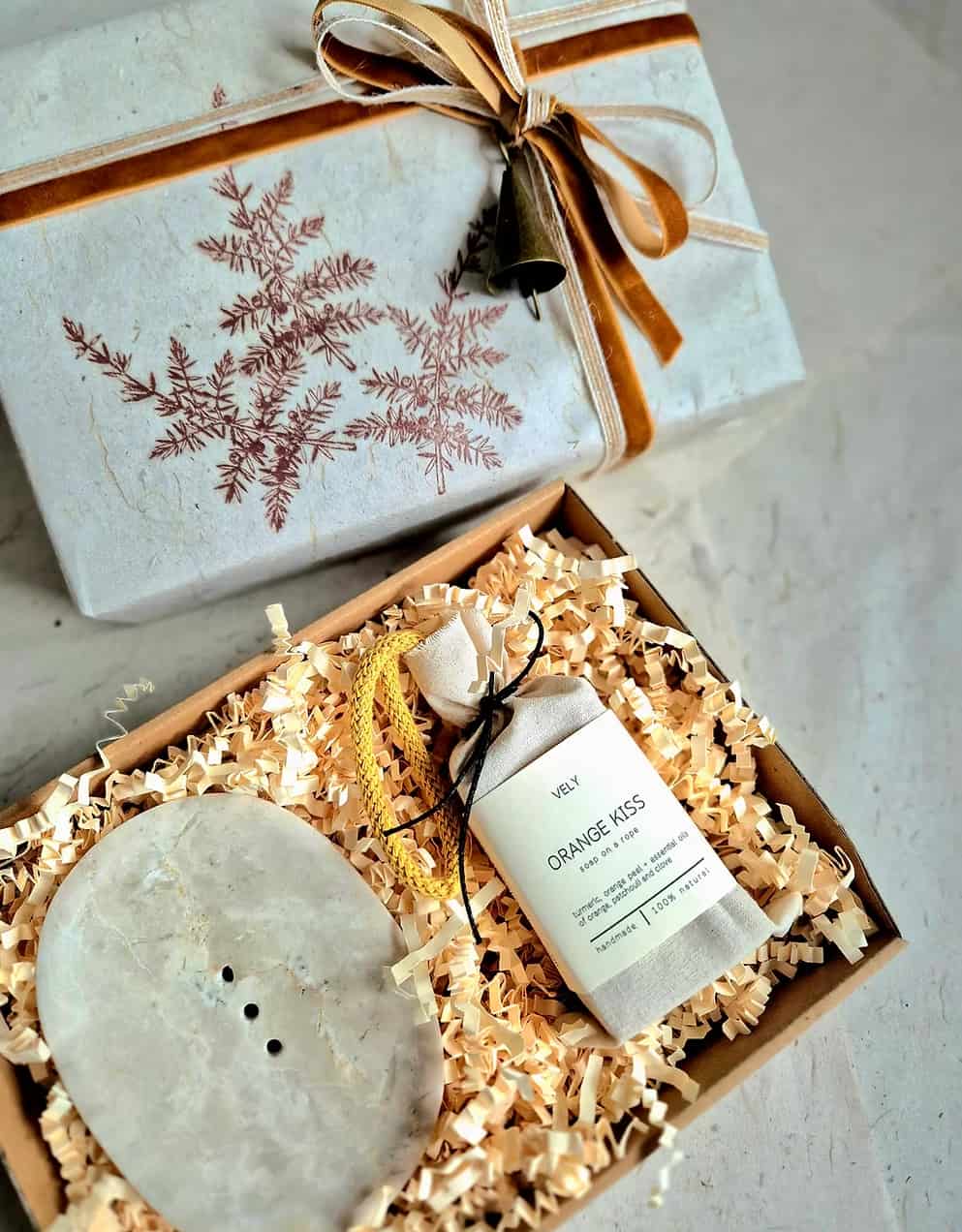Wellness gift set wrapped in hand stamped paper with velvet ribbon