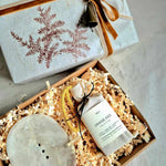 Wellness gift set wrapped in hand stamped paper with velvet ribbon