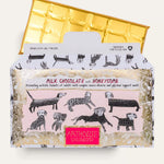 Open milk chocolate honeycomb bar and its wrapper