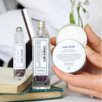 Deepest Sleep pulse point oil, shower mist and hand cream displayed in a wellbeing setting.