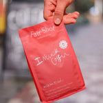 Fair Shot Inclusive Blend coffee bag held by hand