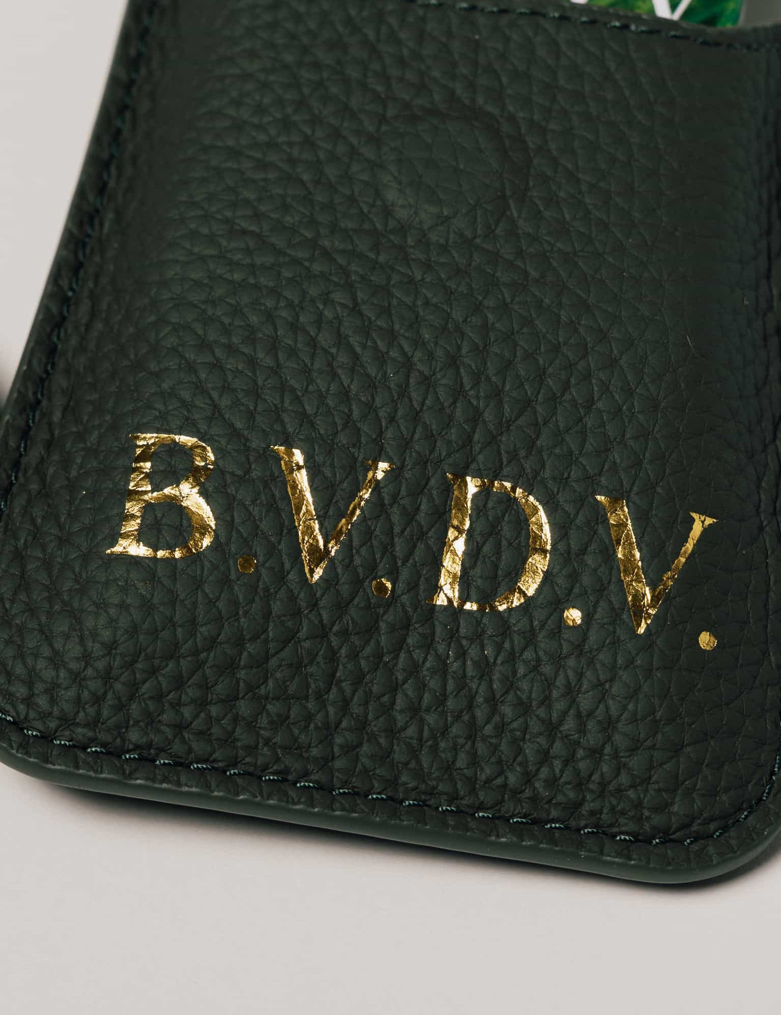 Personalised green leather travel playing cards set, a premium executive gift handcrafted from full grain leather.
