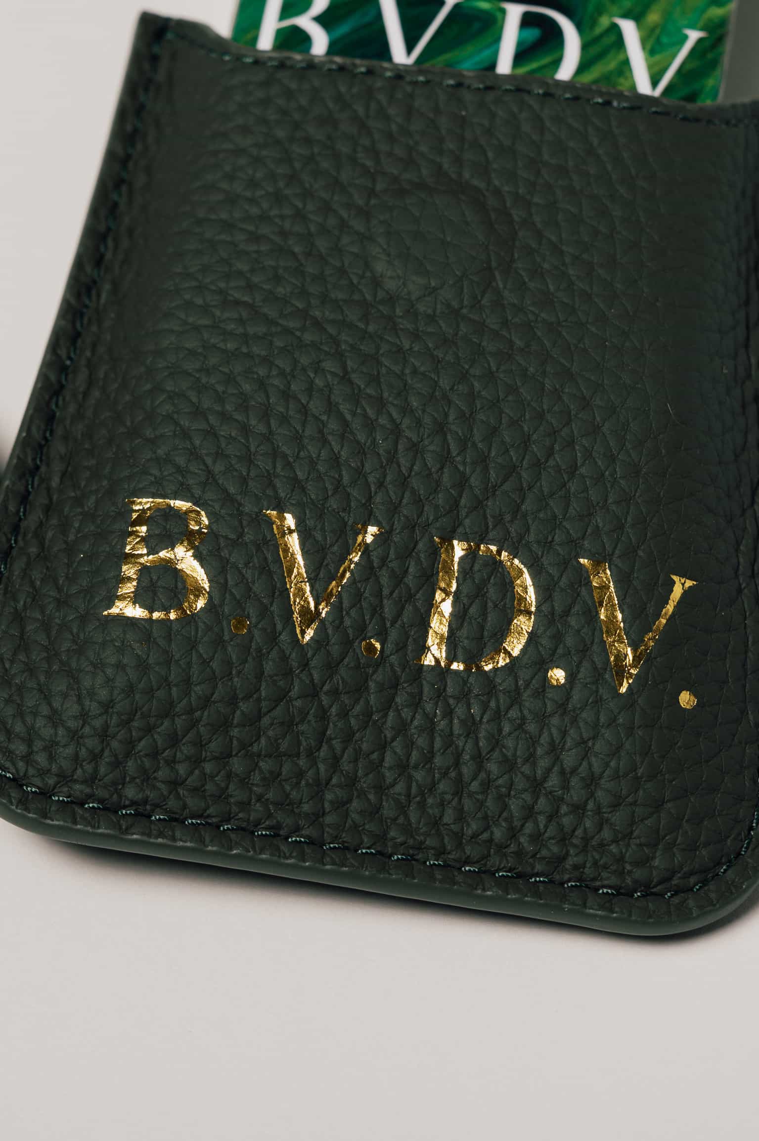 Personalised green leather travel playing cards set, a premium executive gift handcrafted from full grain leather.