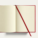 Open A5 travel notebook with cream dot grid pages, gold-gilded edges and ribbon bookmark. Personalised corporate gift for executives, clients and conferences, handmade in England.