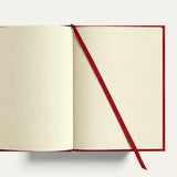 Open A5 travel notebook with cream dot grid pages, gold-gilded edges and ribbon bookmark. Personalised corporate gift for executives, clients and conferences, handmade in England.