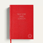 Personalised travel notebook, red A5 hardcover with gold New York Paris London lettering. Sustainable executive corporate gift from women-owned brands, handmade in England.