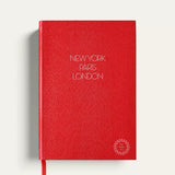 Personalised travel notebook, red A5 hardcover with gold New York Paris London lettering. Sustainable executive corporate gift from women-owned brands, handmade in England.