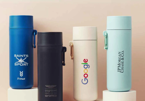 Lifestyle photo of 550ml plant-based reusable water bottles with client logos, sustainable branded merch and corporate gifts from women-owned brands