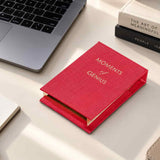Red Moments of Genius refillable notepad on a contemporary office desk with laptop and pen