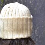 Natural cream ribbed merino wool beanie worn outdoors