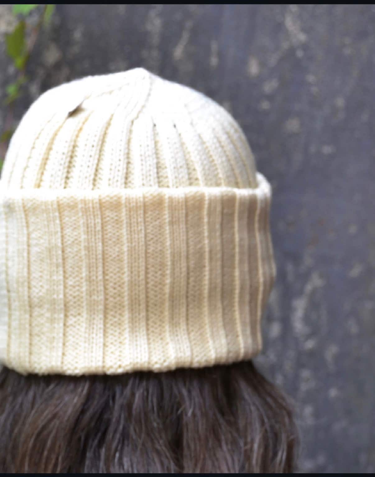 Natural cream ribbed merino wool beanie worn outdoors