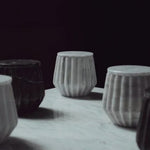 Hand-carved marble jars in grey and black, sustainable gifts for corporate women