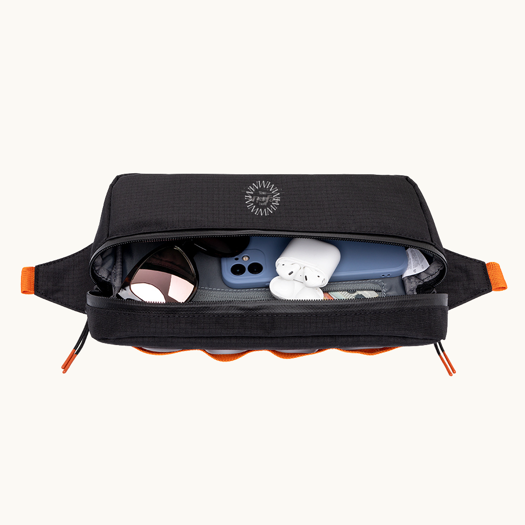 Black recycled PET water-resistant frame bag open, showing organised compartments. Sustainable branded merch